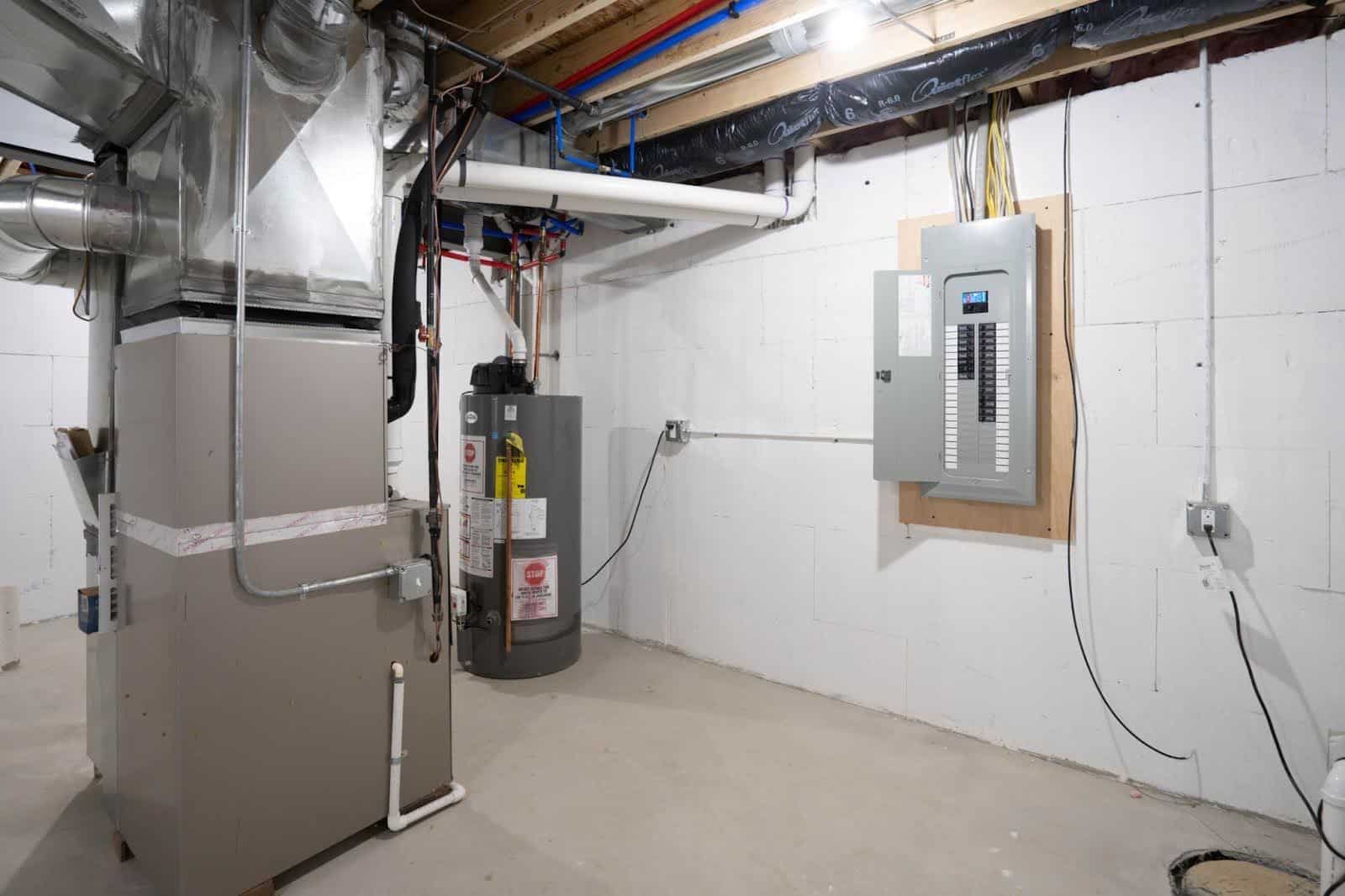 A basement of a residential building with a forced air HVAC system installed.